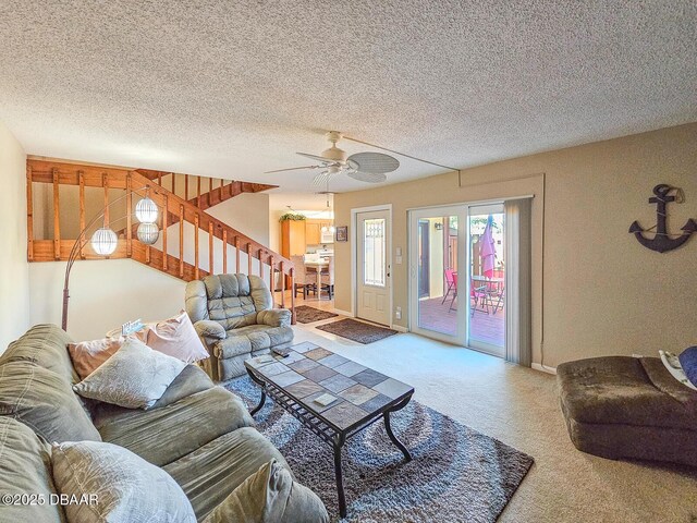 living area featuring stairs, carpet floors, a textured ceiling, and a ceiling fan