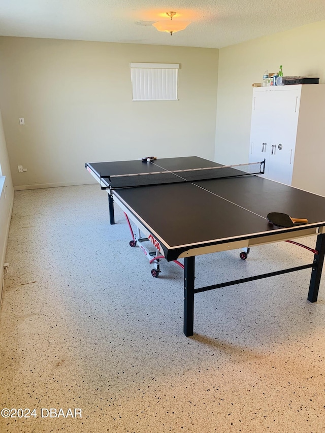 game room with a textured ceiling