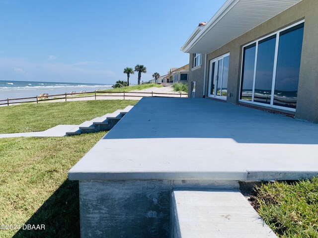 view of yard featuring a water view, a patio, and fence