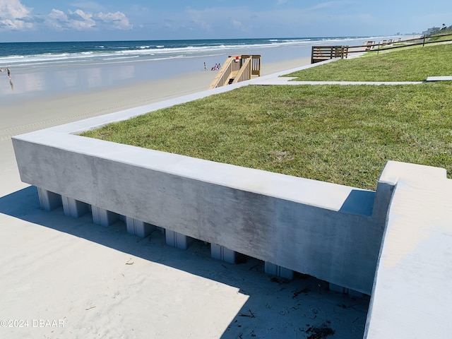 exterior space featuring a water view and a beach view