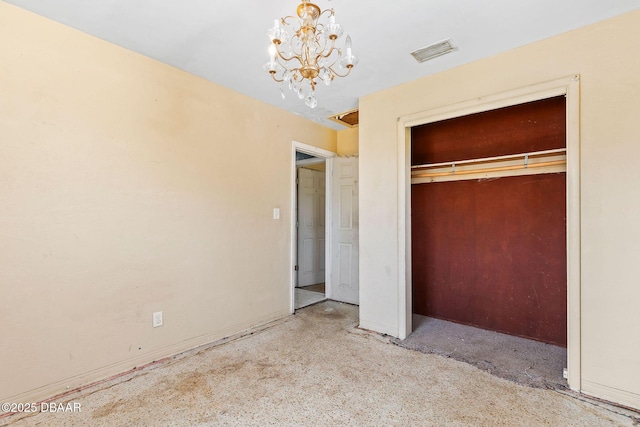 unfurnished bedroom featuring a notable chandelier and a closet