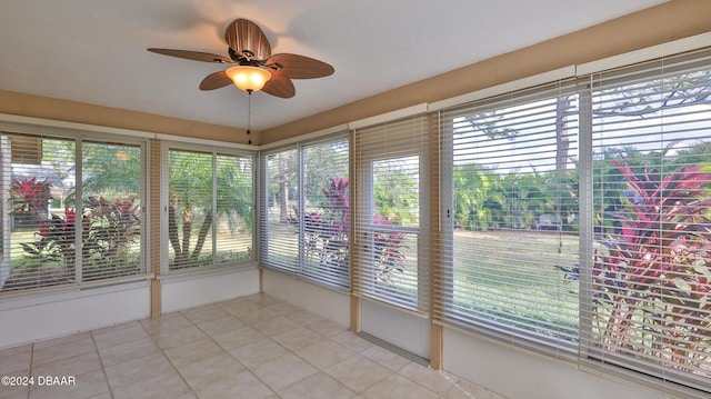 unfurnished sunroom with a ceiling fan