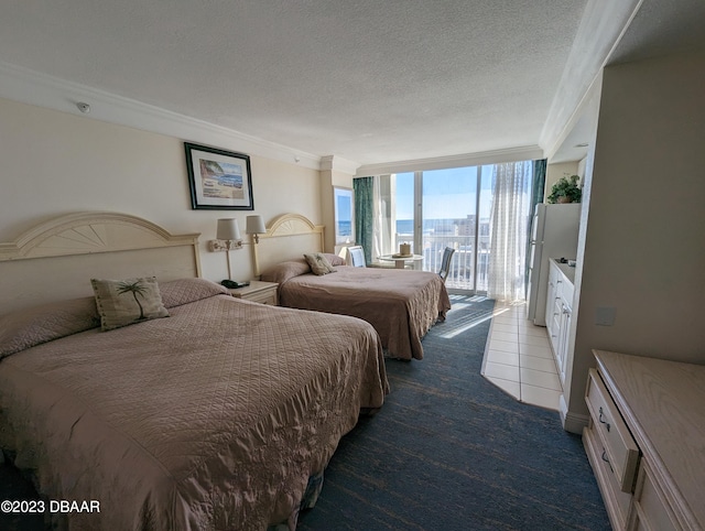 bedroom featuring access to outside, ornamental molding, a textured ceiling, expansive windows, and dark colored carpet