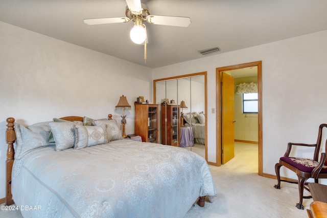 carpeted bedroom featuring a closet and ceiling fan