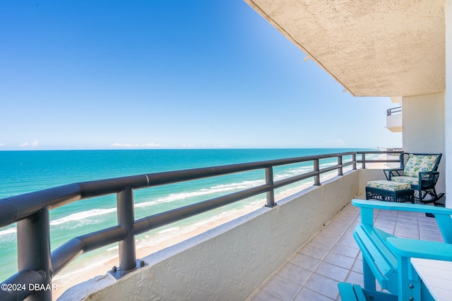 balcony with a view of the beach and a water view