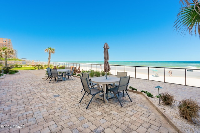 view of patio with a view of the beach and a water view