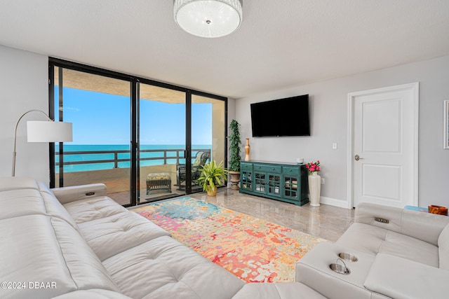 living room with floor to ceiling windows and a textured ceiling