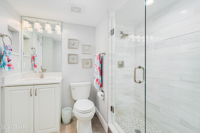 bathroom with vanity, toilet, and a shower with door