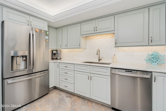 kitchen with crown molding, appliances with stainless steel finishes, sink, and decorative backsplash