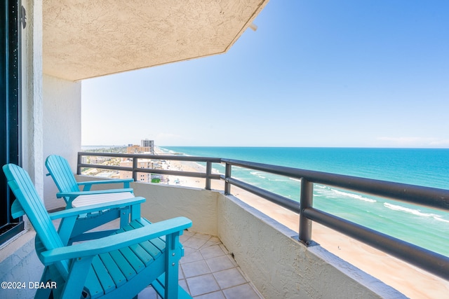 balcony with a water view and a beach view