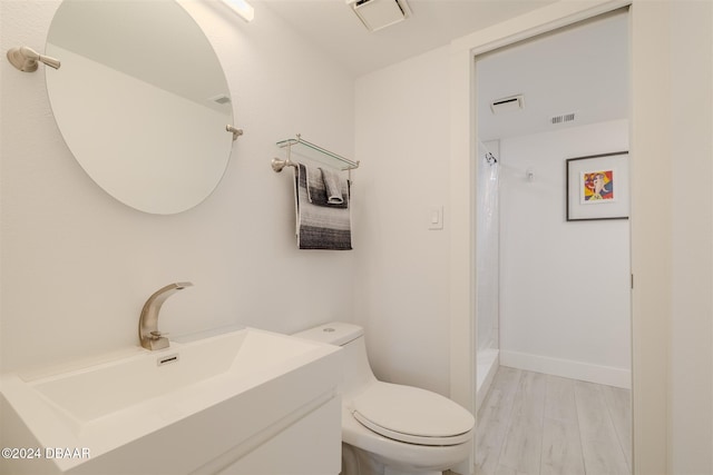 bathroom with a shower with shower curtain, vanity, toilet, and wood-type flooring