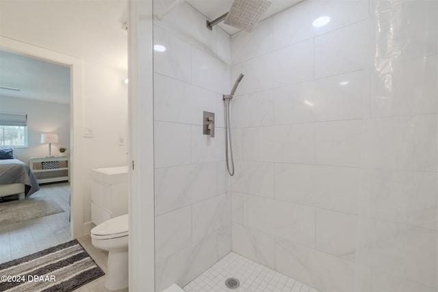 bathroom featuring curtained shower, hardwood / wood-style floors, and toilet