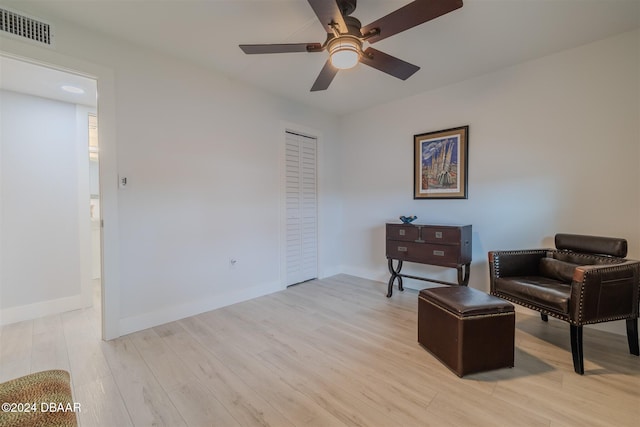 sitting room with ceiling fan and light hardwood / wood-style floors