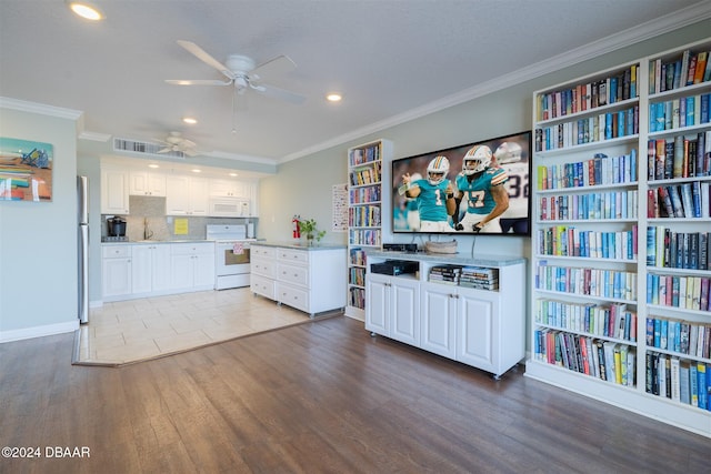 kitchen featuring backsplash, white cabinetry, light hardwood / wood-style flooring, and white appliances