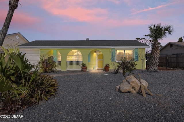 2711 Dach Ave, Daytona Beach, FL 32118 - view of front of home with a garage, fence, and covered porch