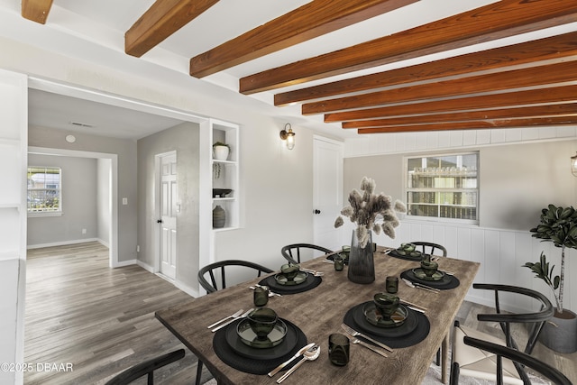 2711 Dach Ave, Daytona Beach, FL 32118 - dining space featuring visible vents, beamed ceiling, baseboards, and wood finished floors