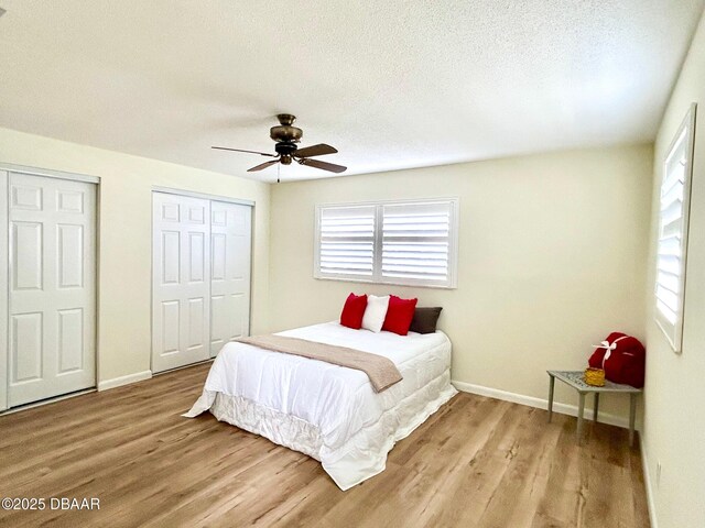 empty room with a textured ceiling, a notable chandelier, and light hardwood / wood-style floors