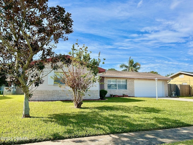 single story home with a garage and a front lawn