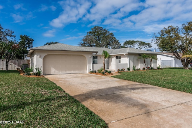 ranch-style home with a front yard, concrete driveway, an attached garage, and stucco siding