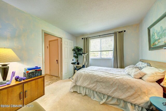 carpeted bedroom with a textured ceiling