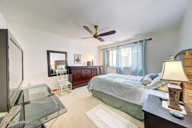 bedroom featuring ceiling fan and light colored carpet