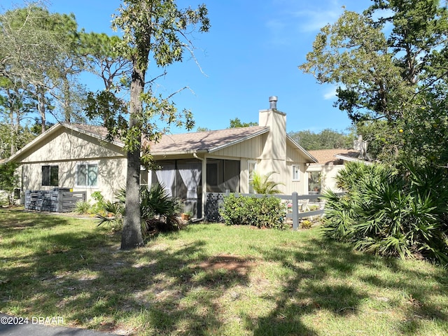 rear view of house featuring a yard