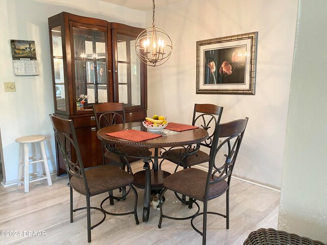 dining area featuring an inviting chandelier and light wood-type flooring