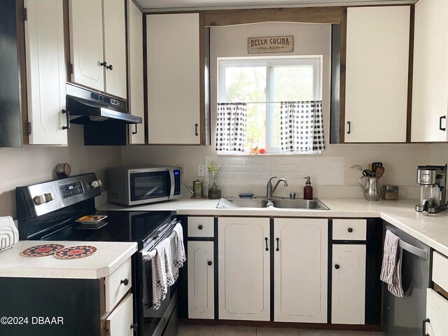 kitchen featuring white cabinetry, sink, decorative backsplash, and appliances with stainless steel finishes