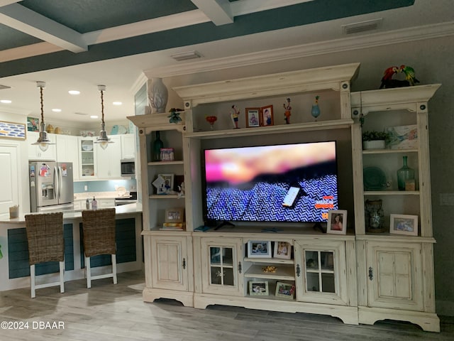 interior space featuring ornamental molding and light hardwood / wood-style flooring