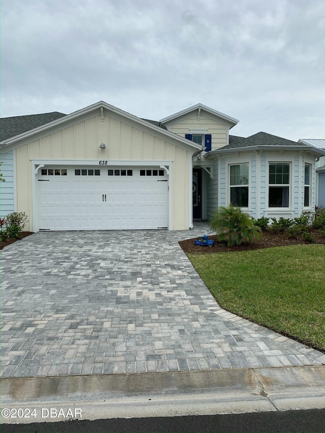 view of front of home featuring a front lawn and a garage