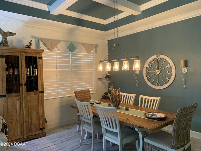 dining area with beamed ceiling, ornamental molding, and hardwood / wood-style flooring