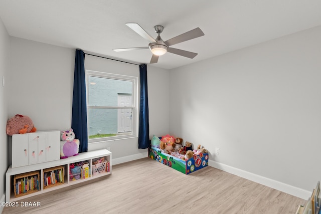 rec room with ceiling fan and light hardwood / wood-style floors