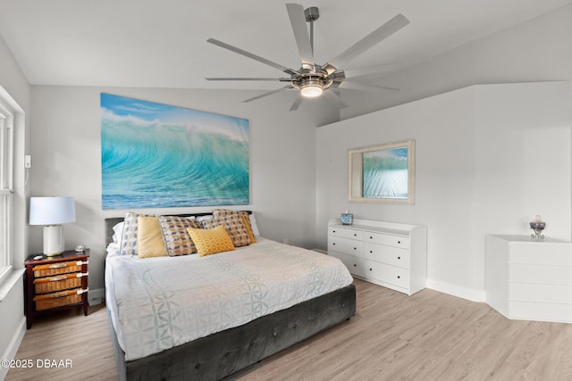 bedroom featuring ceiling fan, light hardwood / wood-style floors, and lofted ceiling