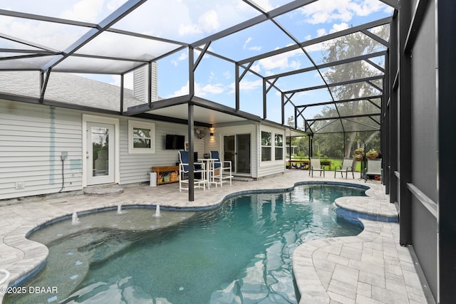 view of swimming pool with a lanai, pool water feature, and a patio