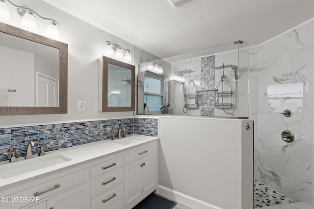 bathroom with decorative backsplash, vanity, and tiled shower