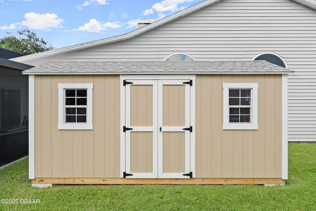 view of outbuilding featuring a yard