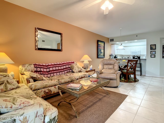 living room featuring light tile patterned flooring and ceiling fan