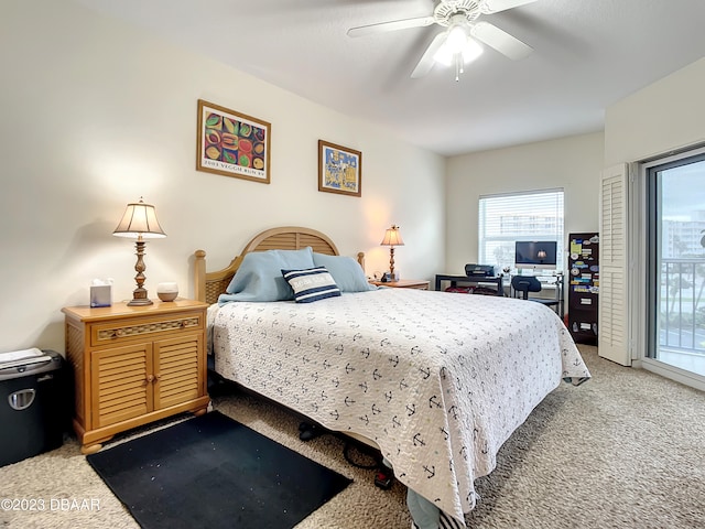 bedroom featuring access to outside, ceiling fan, and carpet