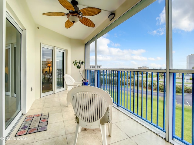 balcony featuring ceiling fan and a water view