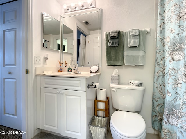 bathroom with vanity, toilet, and a shower with curtain