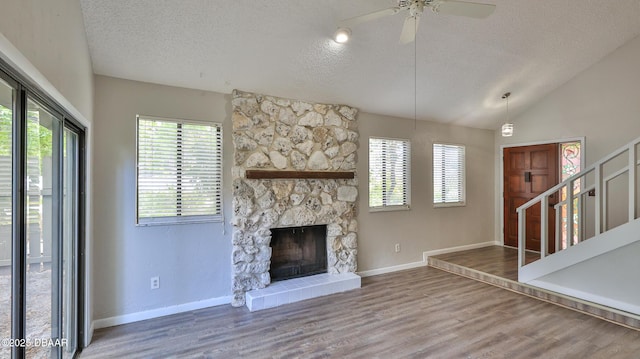 201 Pine Cone Trl, Ormond Beach, FL 32174 - unfurnished living room with vaulted ceiling, baseboards, a textured ceiling, a ceiling fan, and wood finished floors