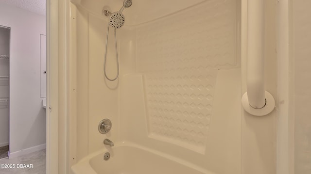 201 Pine Cone Trl, Ormond Beach, FL 32174 - bathroom featuring tile patterned flooring, shower / tub combination, baseboards, and a textured ceiling
