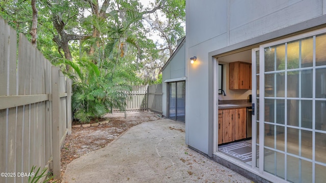 201 Pine Cone Trl, Ormond Beach, FL 32174 - view of patio / terrace featuring a sink and fence