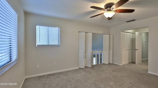 201 Pine Cone Trl, Ormond Beach, FL 32174 - unfurnished bedroom featuring baseboards, carpet flooring, a textured ceiling, and visible vents