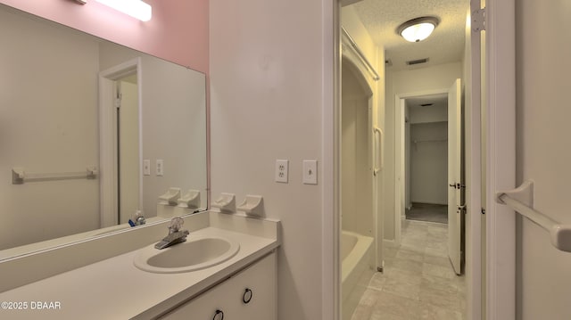 201 Pine Cone Trl, Ormond Beach, FL 32174 - bathroom featuring a textured ceiling, visible vents, and vanity