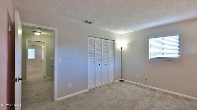 201 Pine Cone Trl, Ormond Beach, FL 32174 - unfurnished bedroom with a closet, carpet, multiple windows, and visible vents