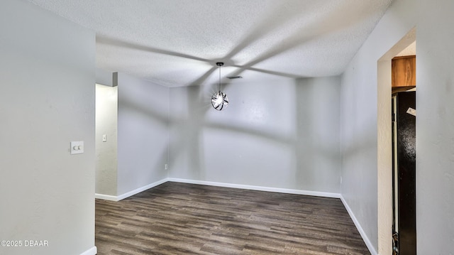 201 Pine Cone Trl, Ormond Beach, FL 32174 - empty room featuring baseboards, visible vents, a textured ceiling, and wood finished floors