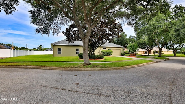 4269 Mayfair Ln, Port Orange, FL 32129 - view of front of house featuring driveway, stucco siding, and a garage