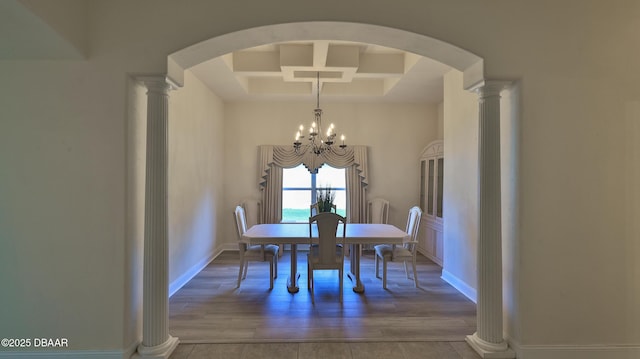 4269 Mayfair Ln, Port Orange, FL 32129 - dining space with coffered ceiling, a chandelier, wood finished floors, arched walkways, and beam ceiling