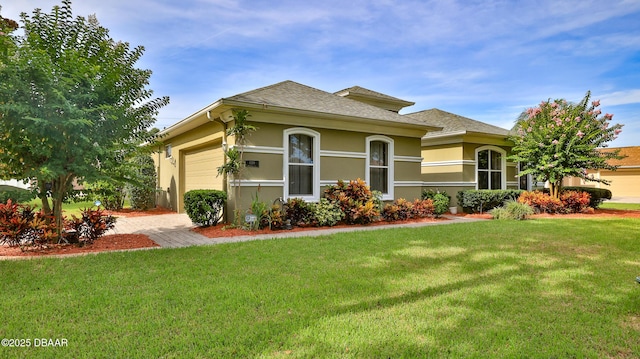 4269 Mayfair Ln, Port Orange, FL 32129 - view of front of house featuring an attached garage, stucco siding, a front yard, and a shingled roof